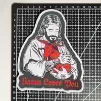 Image 2 of Satan Loves You Jesus Holding A Red Demon Goat Matte Vinyl Sticker