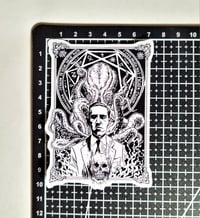 Image 2 of H.P. Lovecraft Holding A Skull With Cthulu In The Background Matte Vinyl Sticker