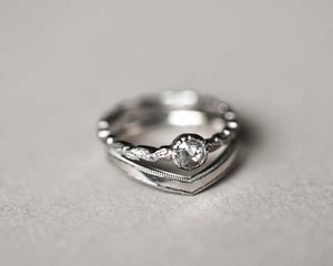 Image of Platinum 2mm width milled edge wishbone shaped ring.
