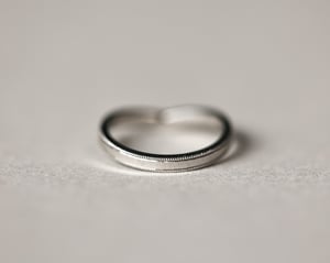 Image of Platinum 2mm width milled edge wishbone shaped ring.