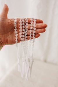 Image 1 of Dainty flower tieback with elastic back 