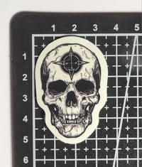 Image 2 of Glow In The Dark Skull With 4 Directions Symbol On Forehead Glossy Finish Vinyl Sticker