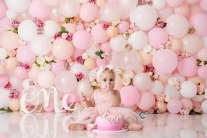 Image of Pink and Peach Balloon Wall with Flowers 