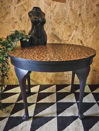 Image 1 of Black Leopard Table. 
