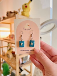Image 1 of star and moon stamp dangle earrings