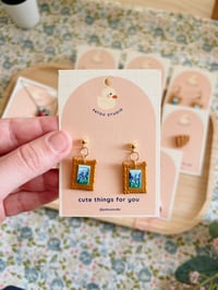 Image 2 of cottage core tiny paintings dangle earrings | cat, forest, river