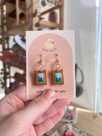Image 4 of cottage core tiny paintings dangle earrings | cat, forest, river