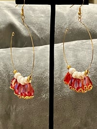 Large hoop earrings with freshwater pearls and red glass teardrop beads.