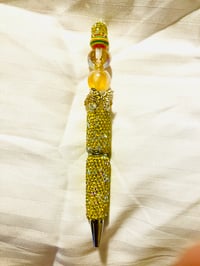 Yellow and gold rhinestone pen with butterfly focal and rainbow bead. 