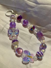 Striped acrylic bead phone chain with butterfly and turtle focals