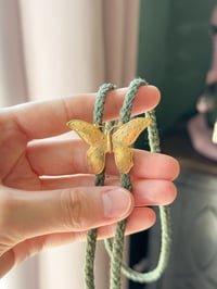 Image 1 of brass butterfly bolo tie