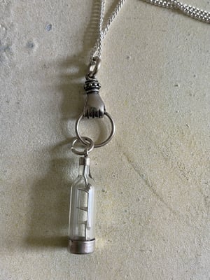 Image of Vintage silver necklace with hand & ship in a bottle charms 