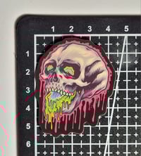 Image 2 of Glow In The Dark Skull Drooling Slime Matte Vinyl Sticker