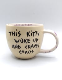 Image 2 of This kitty woke up and craves chaos 🫐