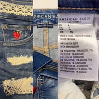 Image 3 of American Eagle distressed dark denim cut off shorts  w-ivory crochet peeking through