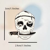 Image 2 of Wobbly Eye'd Skull With Spider Web Handled Dagger In Its Mouth Enamel Pin