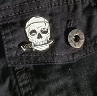 Image 4 of Wobbly Eye'd Skull With Spider Web Handled Dagger In Its Mouth Enamel Pin