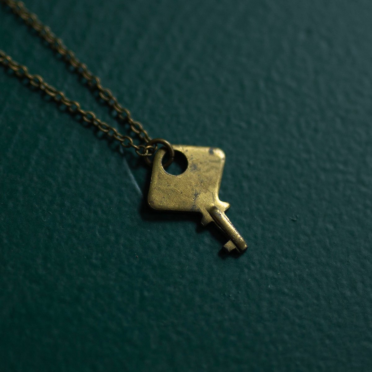 Tiny diamond-shaped brass key necklace