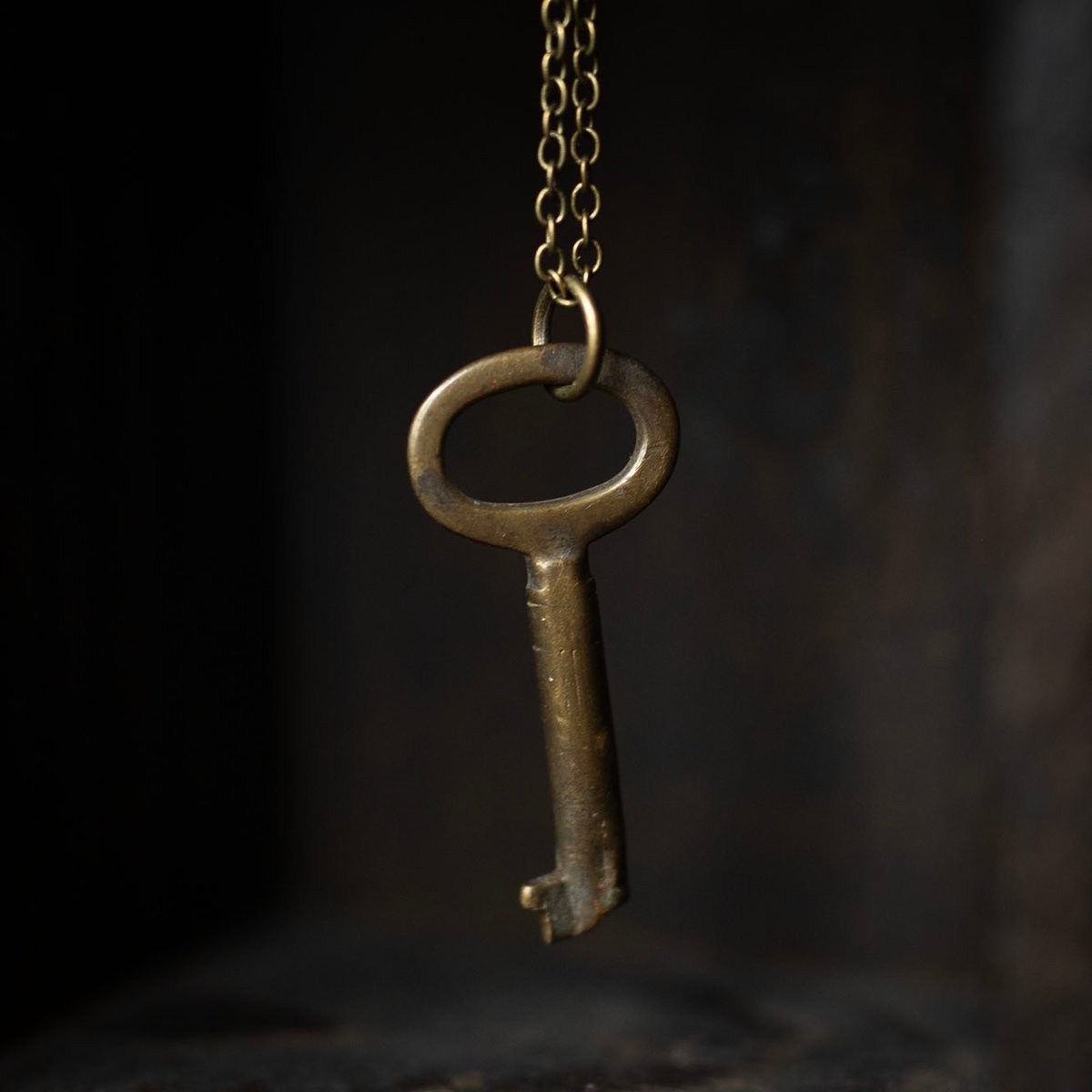 Small oval-shaped brass skeleton key necklace