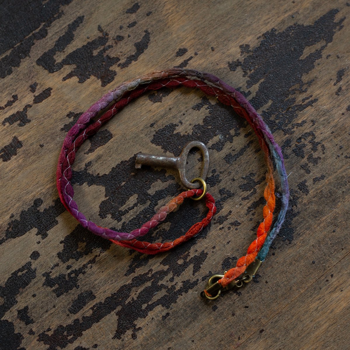 Tiny oval barrel key on silk "Sunset" cord