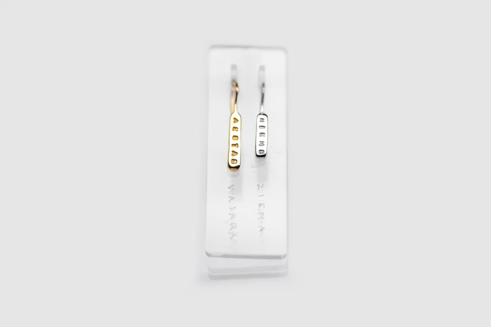 Image of Plain light silver earrings with gilding and without with inscription in Latin