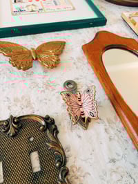 Image 1 of brass butterfly wall clip
