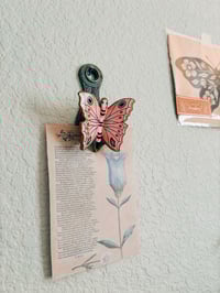Image 2 of brass butterfly wall clip