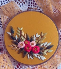 Image 1 of 6” Pink floral embroidery with green leaves on mustard fabric