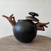Image 2 of a handheld teapot