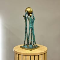 Image 2 of Family Holding The Globe 40cm