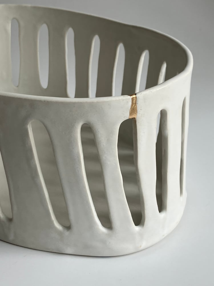 Image of porcelain basket with a kintsugi repair