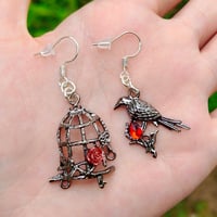 Image 1 of Red Gem Crow and Cage Asymmetric Earrings