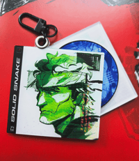 Image 1 of MGS - SOLID SNAKE CD CHARM