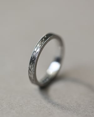 Image of Platinum 2mm flat court ‘Olive leaf’ and milled edge engraved ring