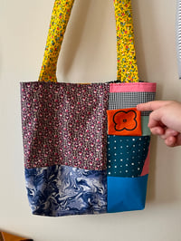 Image 1 of tote with orange flower flap