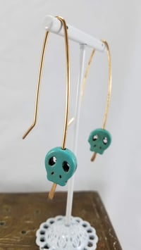 Image 2 of Smash it Pretty Festive Skull Silhouette Red or Yellow Elf Ear Long Bronze Earrings f...
