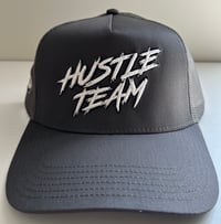 Image 1 of Hustle Team Trucker Snap Hat (Dark Grey with White)