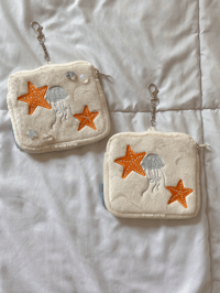 Image 1 of oopsies: on the shore plush pouch