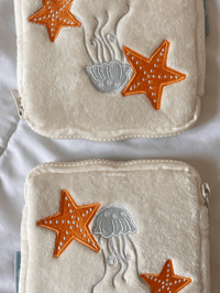 Image 2 of oopsies: on the shore plush pouch