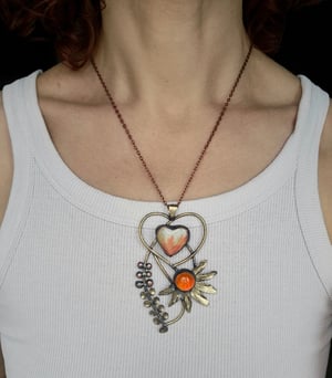 Heart pendant with orange flower