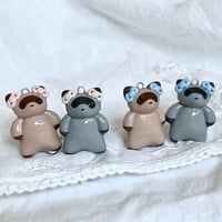 Image 2 of raccoons with bows