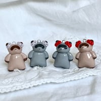 Image 3 of raccoons with bows