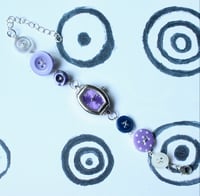 Image 1 of purple button watch