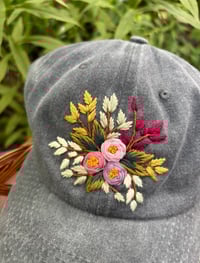Image 1 of Pink and purple hand embroidered flowers on an adjustable grey hat