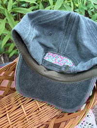 Image 4 of Pink and purple hand embroidered flowers on an adjustable grey hat