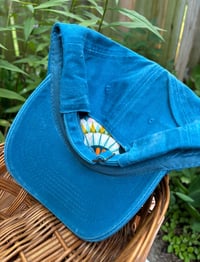Image 4 of Blue and pink hand embroidered flowers on an adjustable blue hat