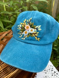Image 3 of Blue and pink hand embroidered flowers on an adjustable blue hat