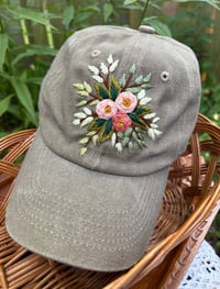 Image 1 of Dark and light pink hand embroidered flowers on an adjustable khaki colour hat