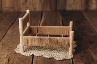 Image 6 of A wooden bed wrapped with thick rope