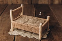 Image 1 of A wooden bed wrapped with thick rope